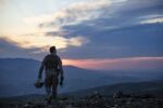 Army Soldier walking against sunset