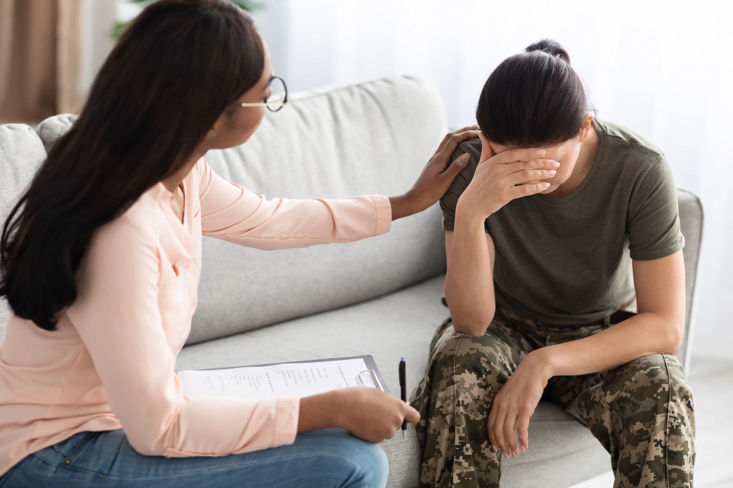 Black Psychologist Lady Comforting Soldier Woman In Uniform During Therapy Session In Office, Professional Psychotherapist Supporting Depressed Military Female Suffering Mental Problems, Closeup